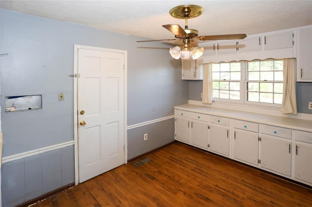 3462 Fairview Road Covington, GA 30016 - Photo 13 of 55 a kitchen with a white cabinets and chandelier