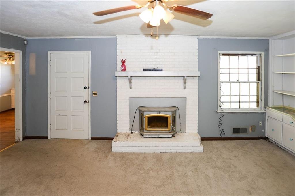 3462 Fairview Road Covington, GA 30016 - Photo 16 of 55 an empty room with windows and fireplace