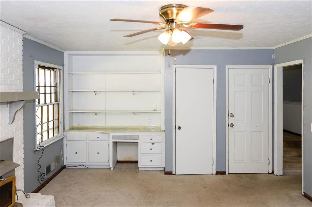 3462 Fairview Road Covington, GA 30016 - Photo 18 of 55 a view of a livingroom with a chandelier fan and windows