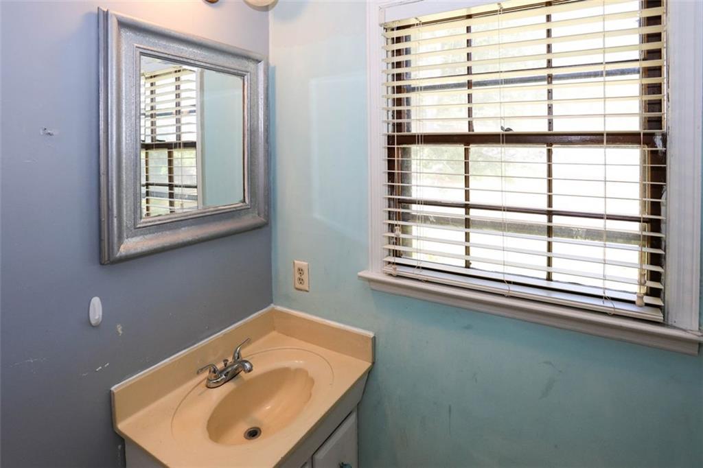3462 Fairview Road Covington, GA 30016 - Photo 25 of 55 a bathroom with a sink window and a mirror