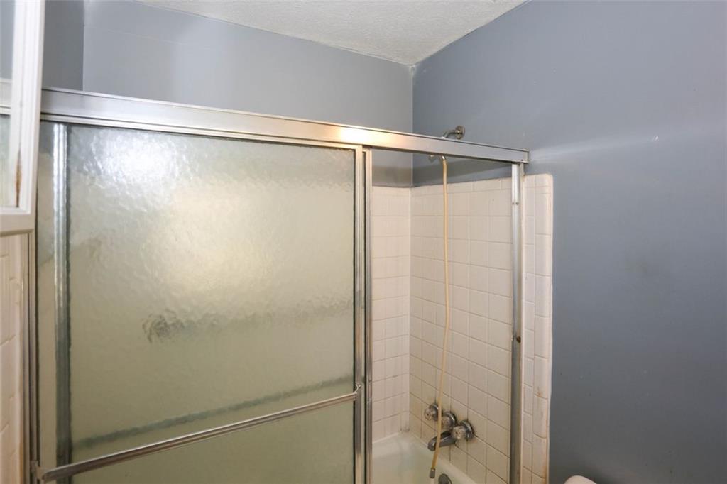 3462 Fairview Road Covington, GA 30016 - Photo 26 of 55 a bathroom with a glass shower door
