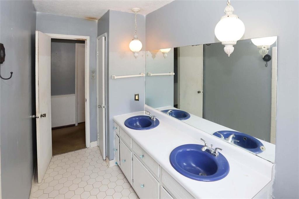 3462 Fairview Road Covington, GA 30016 - Photo 33 of 55 a bathroom with a sink and mirror