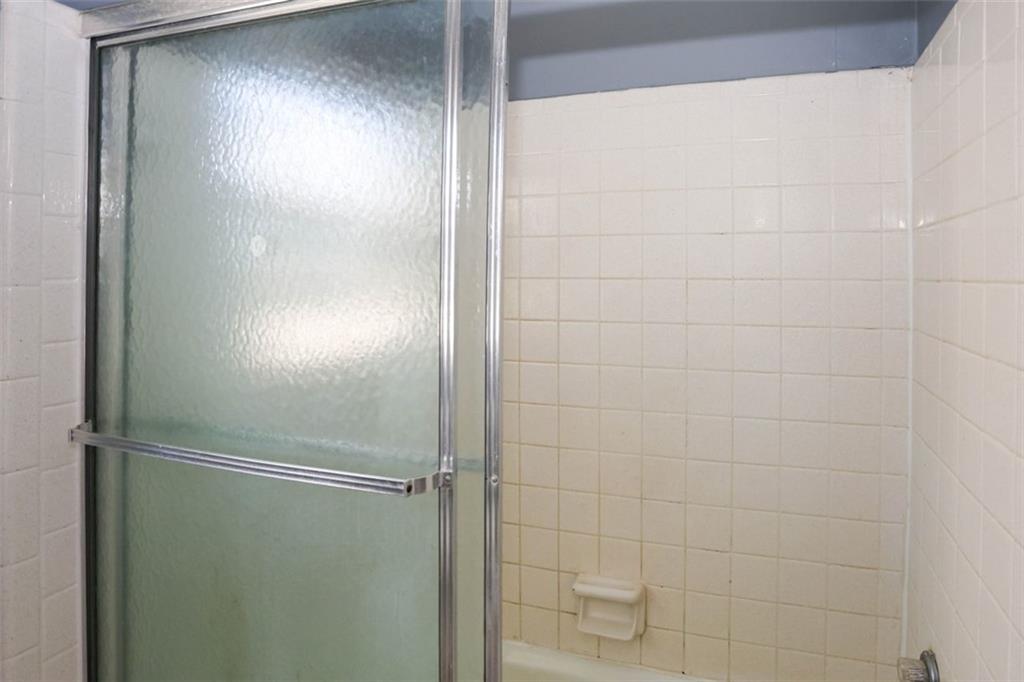 3462 Fairview Road Covington, GA 30016 - Photo 34 of 55 a bathroom with a glass shower door