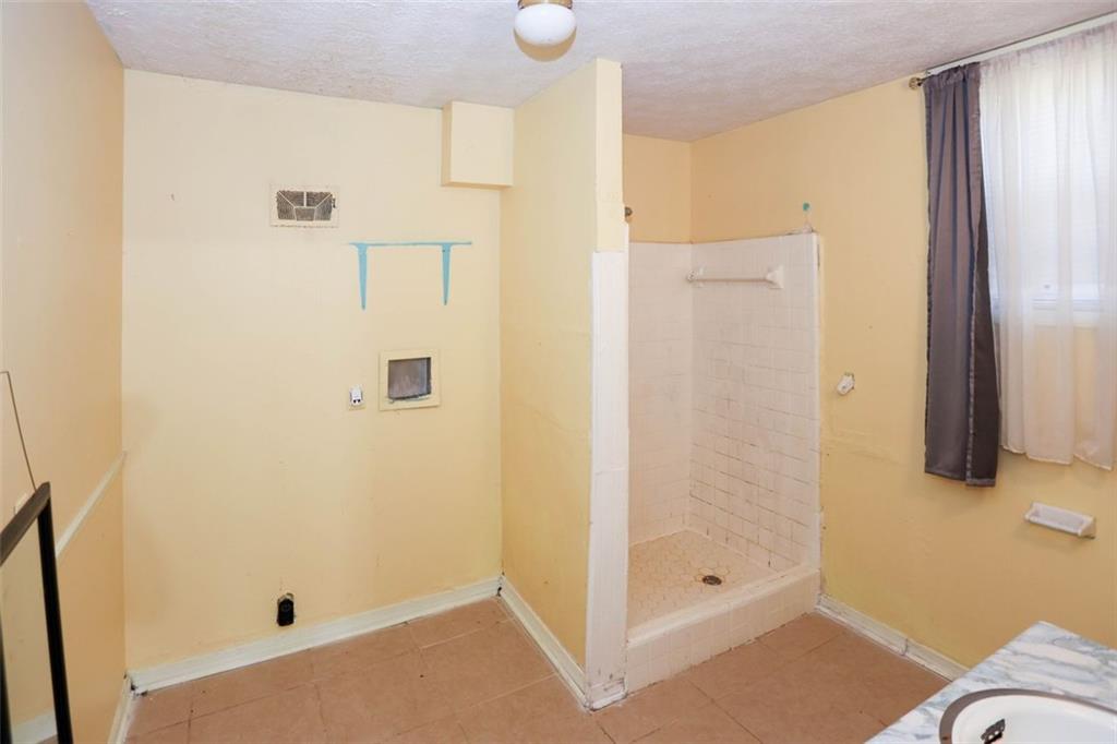 3462 Fairview Road Covington, GA 30016 - Photo 41 of 55 a bathroom with a shower