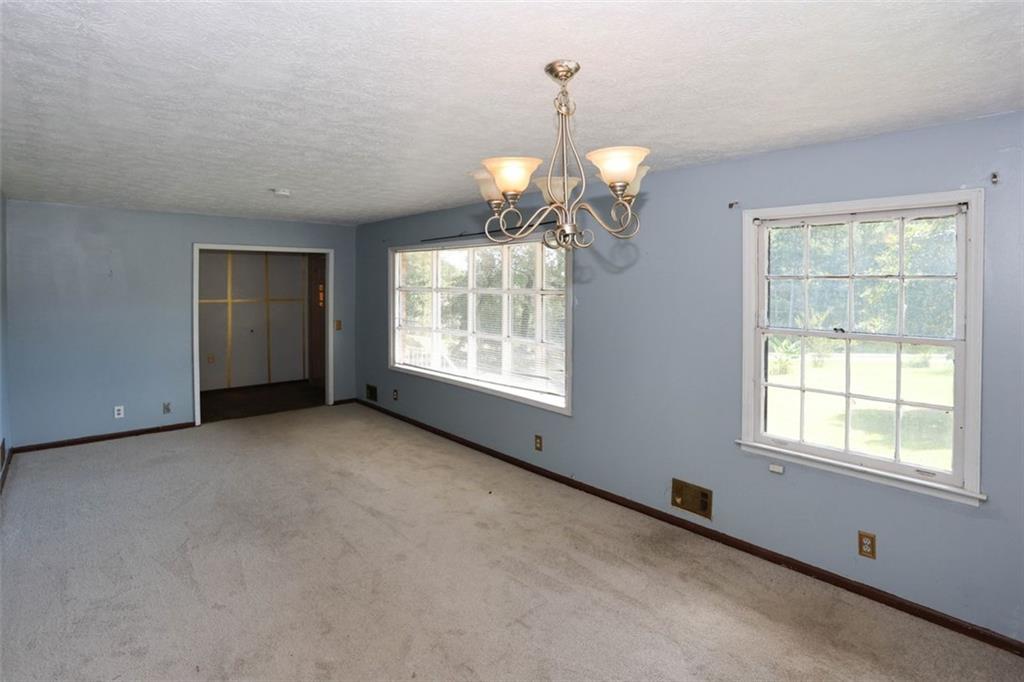 3462 Fairview Road Covington, GA 30016 - Photo 7 of 55 a view of an empty room with a window