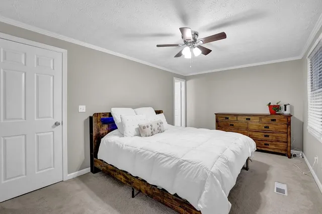 a bedroom with a bed and a chandelier