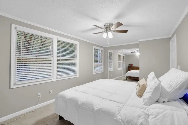 a bedroom with a large bed and a window