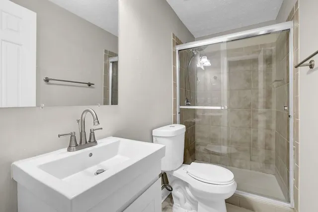 a bathroom with a sink toilet and shower