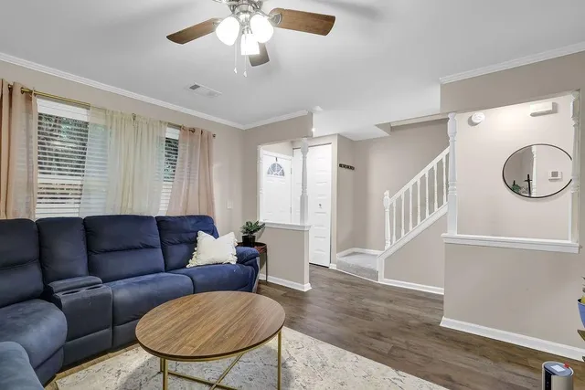a living room with furniture a couch and a chandelier