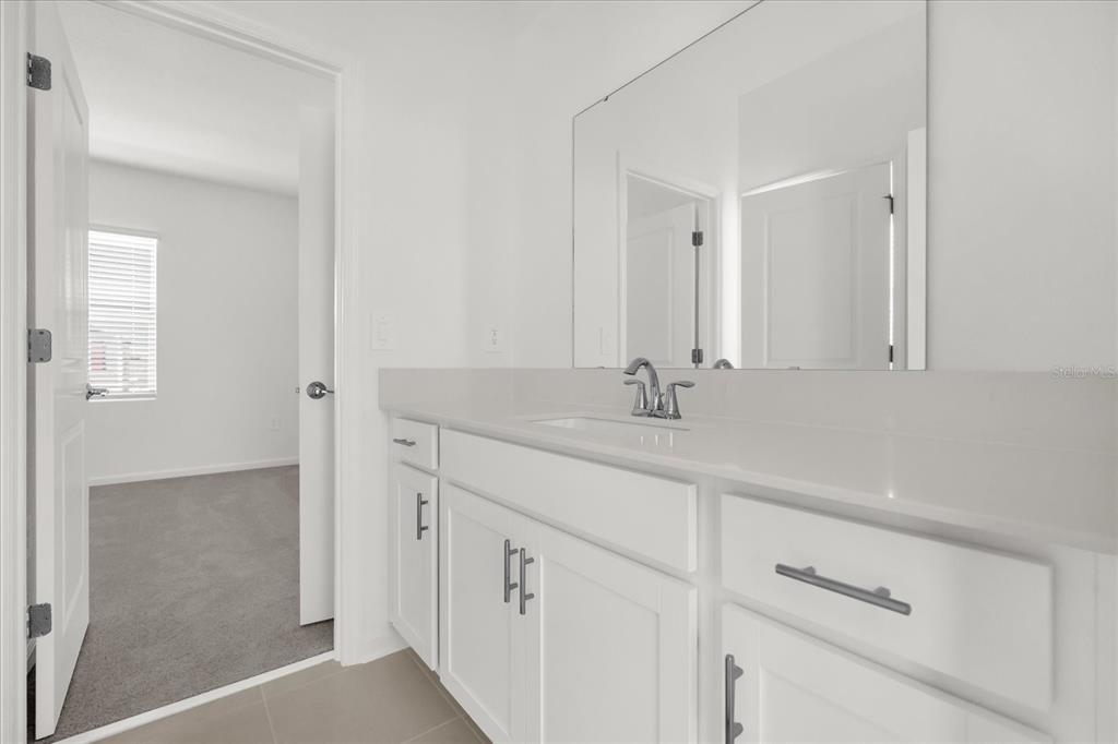 2911 Transformation Way Clermont, FL 34714 - Photo 15 of 27 a bathroom with a sink and a mirror