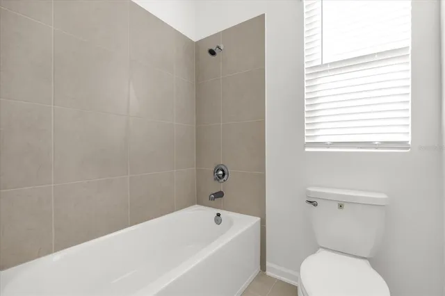 a bathroom with a toilet and bathtub