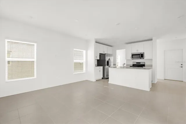 a view of kitchen with stainless steel appliances refrigerator oven and microwave