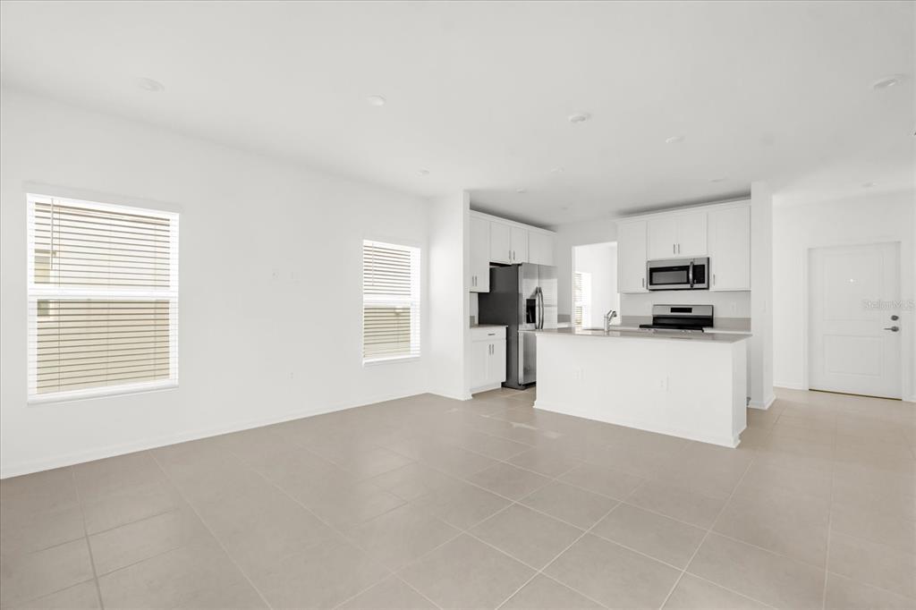 2911 Transformation Way Clermont, FL 34714 - Photo 4 of 27 a view of kitchen with stainless steel appliances refrigerator oven and microwave