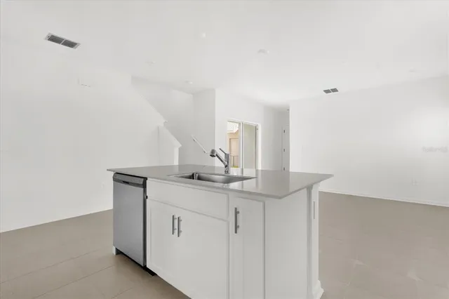 a kitchen with white cabinets and a sink