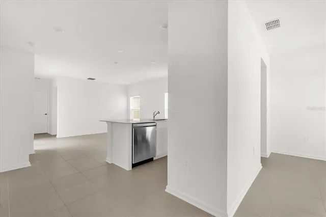 a view of a kitchen with a sink and a refrigerator