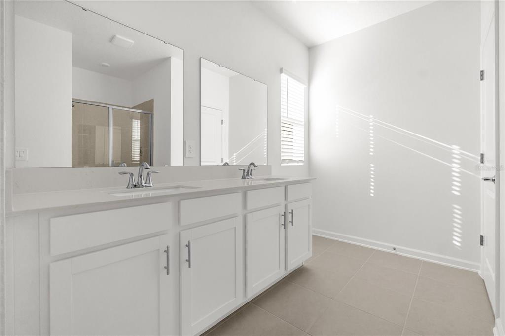 2911 Transformation Way Clermont, FL 34714 - Photo 9 of 27 a bathroom with double sink and a mirror