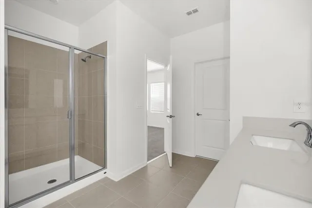 a bathroom with a shower and a sink