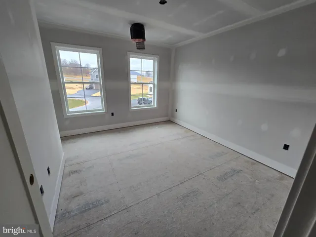 an empty room with windows and entrance