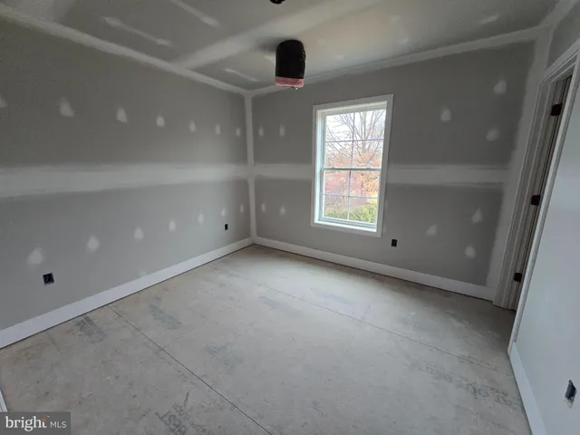 an empty room with windows and entrance