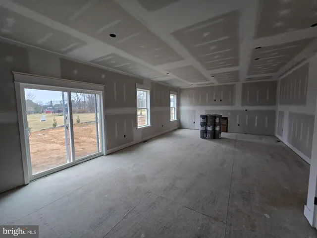 a view of empty room with a fireplace and window