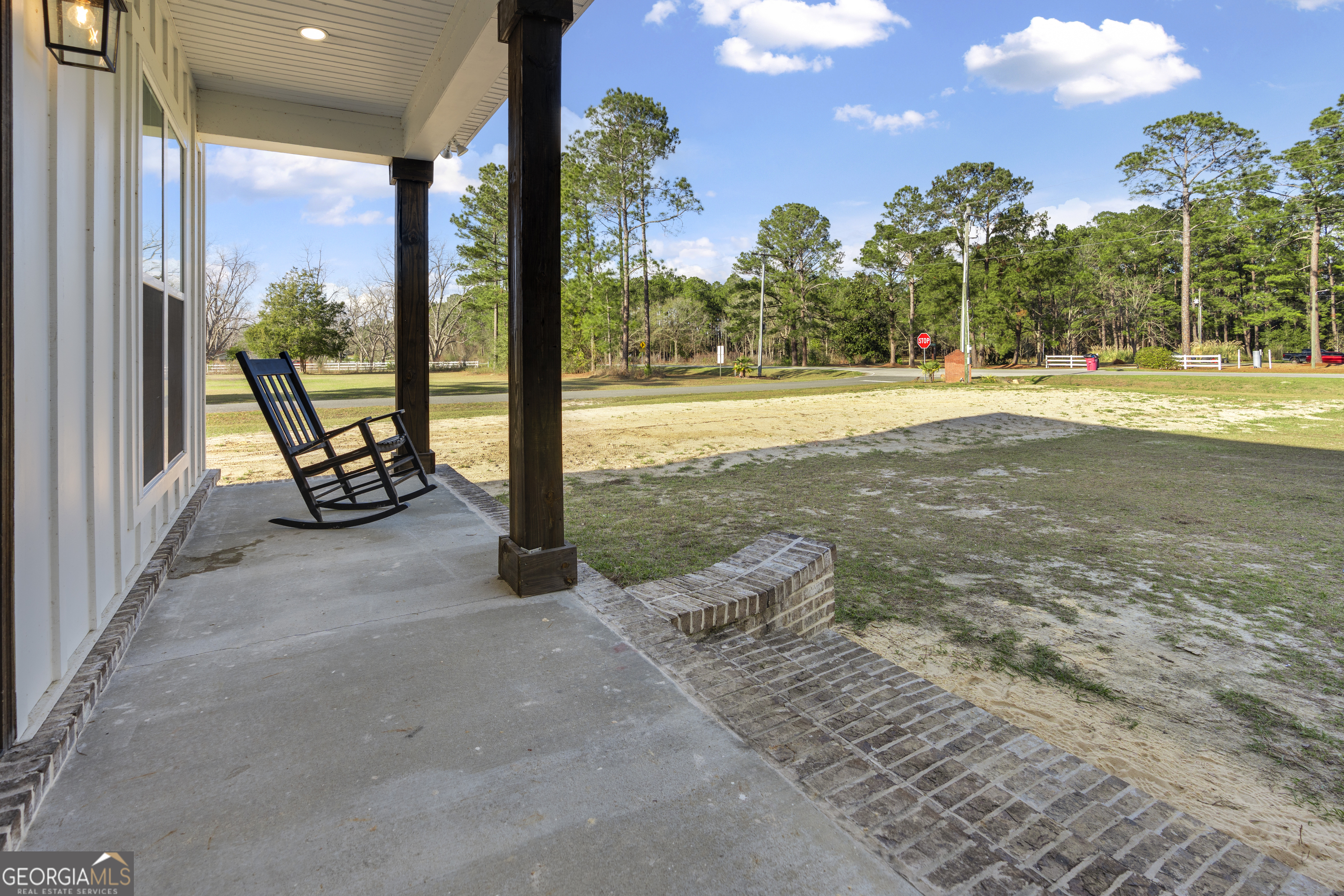4005 Golfview Drive Blackshear, GA 31516 - Photo 39 of 40 a view of a swimming pool with lawn chairs and floor to ceiling window