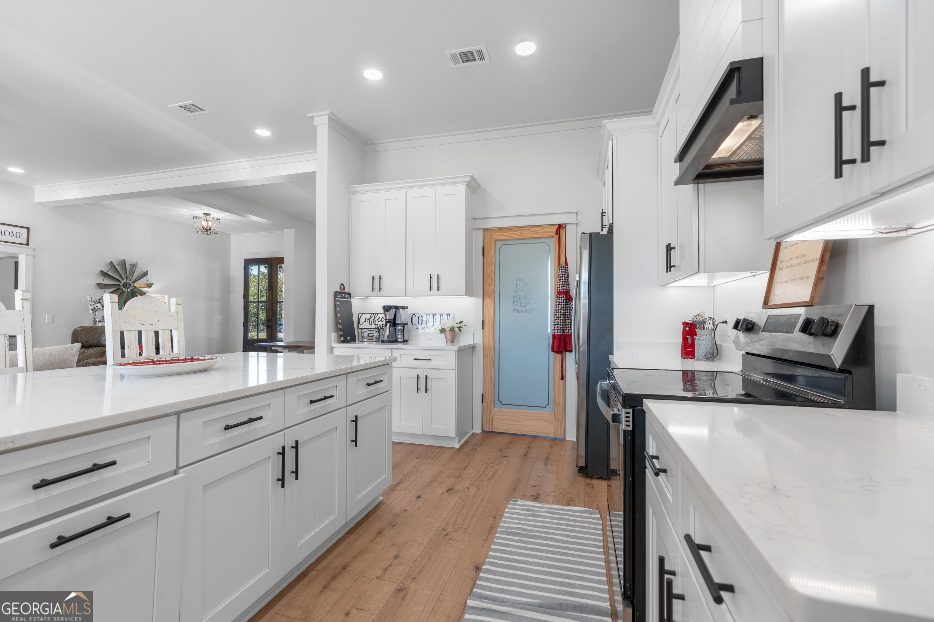 4005 Golfview Drive Blackshear, GA 31516 - Photo 6 of 40 a kitchen with white cabinets and stainless steel appliances