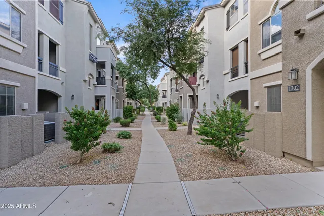 a view of a pathway with a garden