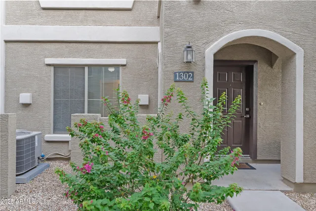 front view of a house with potted plants