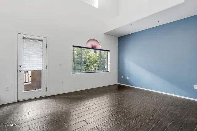 a view of a kitchen with refrigerator and windows
