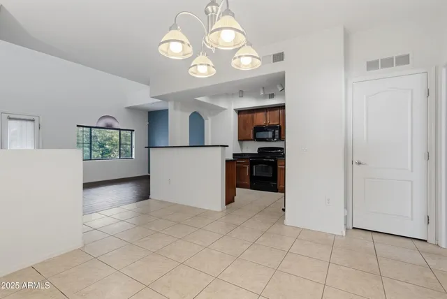 a view of a kitchen with wooden floor and a sink