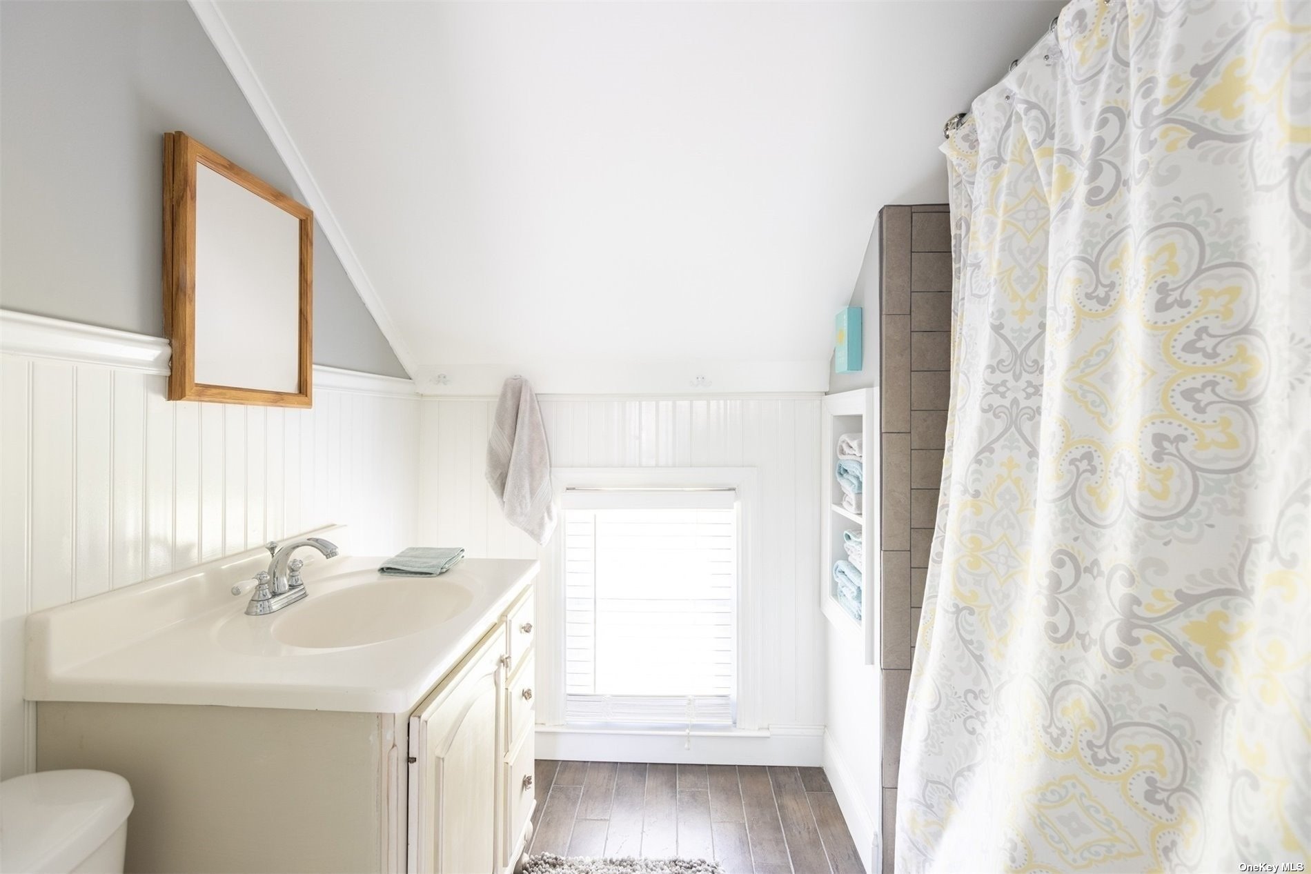 45 Southold, undefined 00000 - Photo 13 of 21 a bathroom with a sink a toilet and a mirror