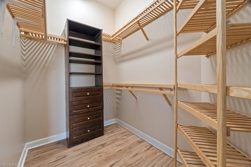 3343 Sandpiper Way Naples, FL 34109 - Photo 13 of 31 Spacious closet featuring hardwood / wood-style flooring