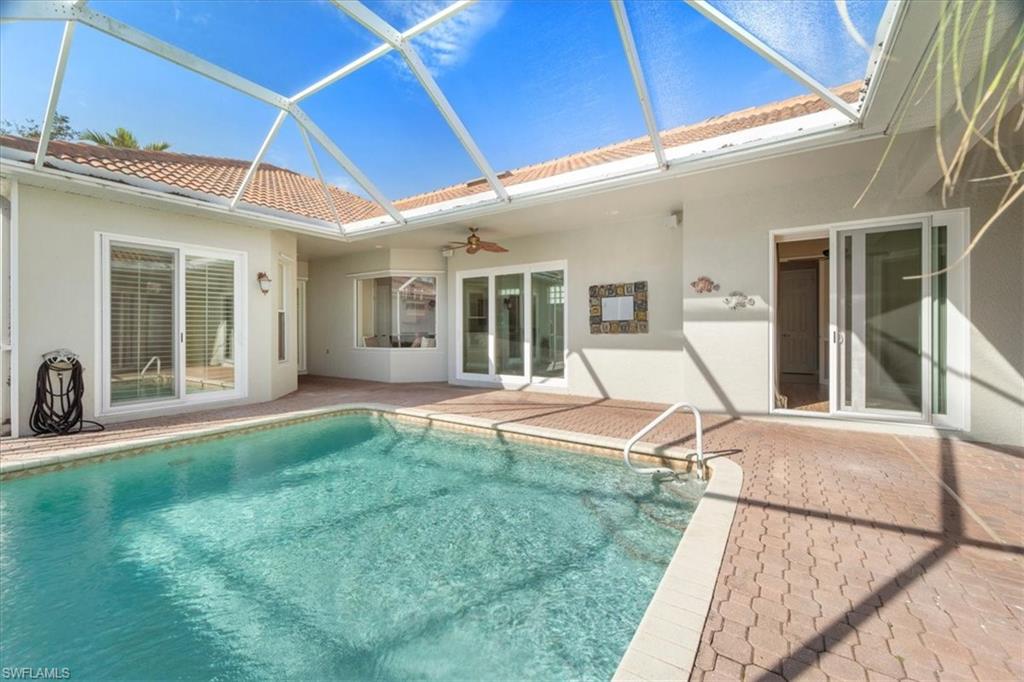 3343 Sandpiper Way Naples, FL 34109 - Photo 17 of 31 View of swimming pool featuring a lanai, ceiling fan, and a patio