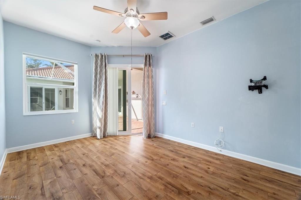 3343 Sandpiper Way Naples, FL 34109 - Photo 19 of 31 Empty room with ceiling fan and light hardwood / wood-style flooring