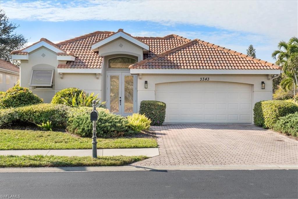 3343 Sandpiper Way Naples, FL 34109 - Photo 23 of 31 Mediterranean / spanish-style house featuring french doors and a garage