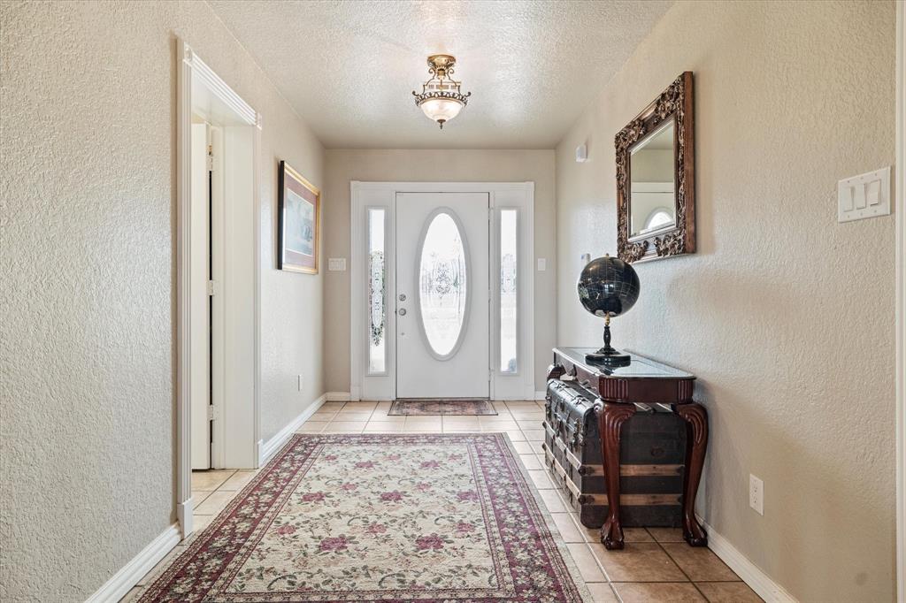 20175 Willow Glade Circle Pilot Point, TX 76258 - Photo 22 of 32 Tiled foyer featuring a textured ceiling