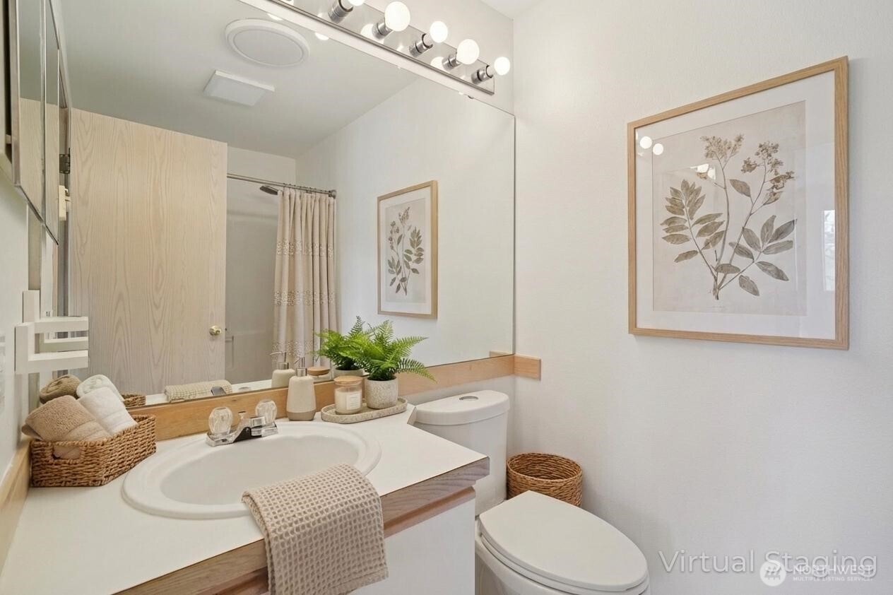 23628 55th Place South, Unit 153 Kent, WA 98032 - Photo 18 of 28 a bathroom with a toilet sink and mirror