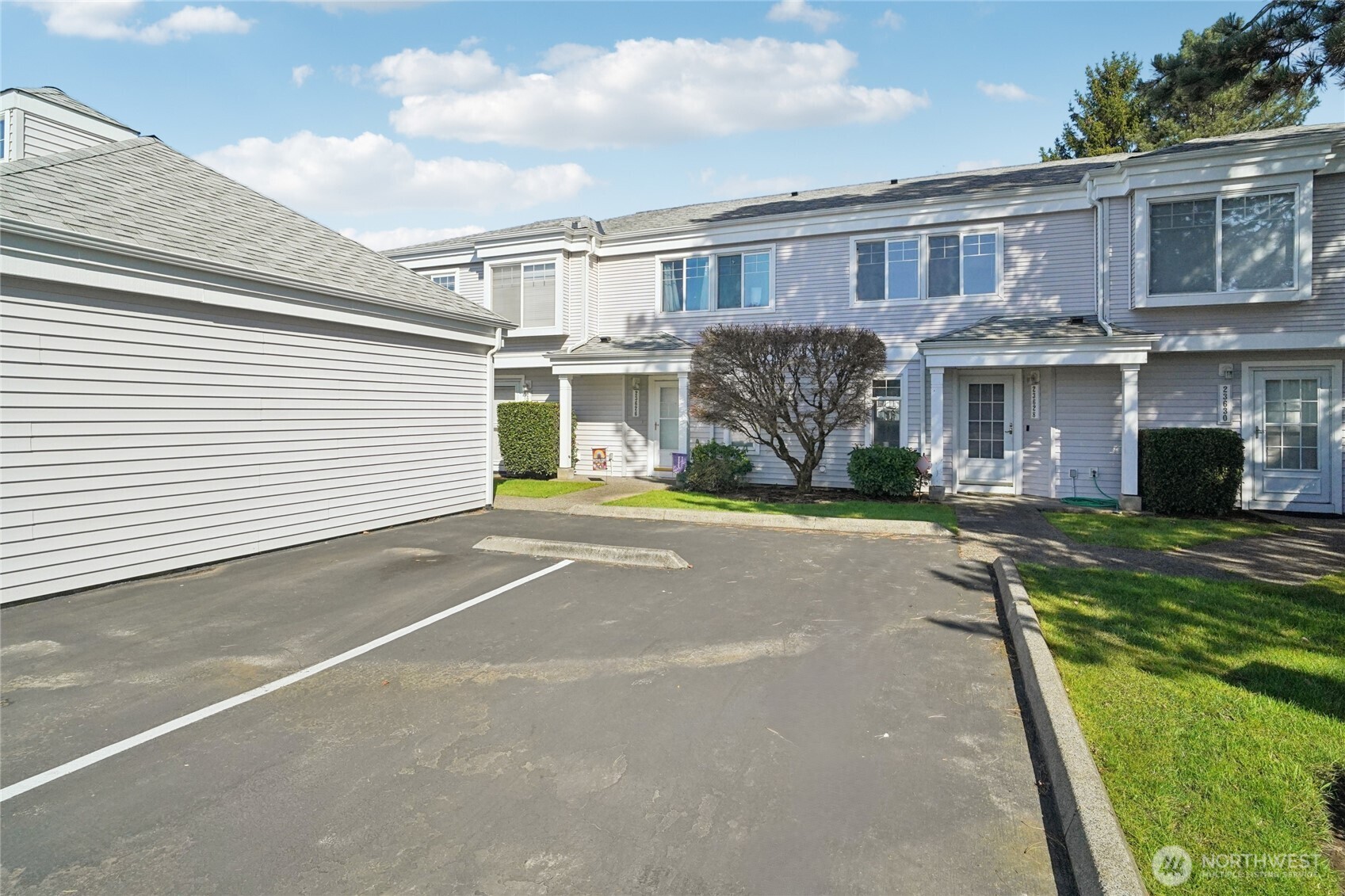 23628 55th Place South, Unit 153 Kent, WA 98032 - Photo 2 of 28 a view of a white house with a yard