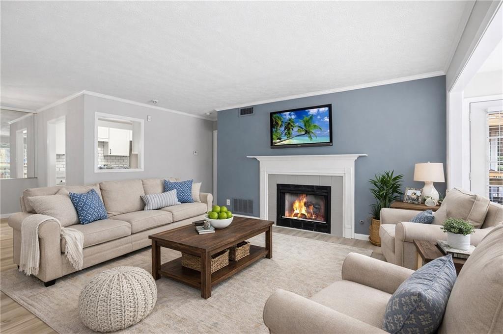106 Berkeley Woods Drive Duluth, GA 30096 - Photo 2 of 17 a living room with furniture and a fireplace