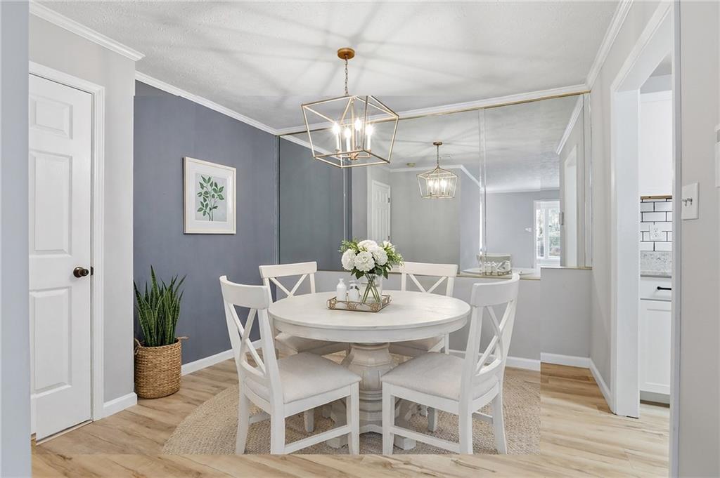 106 Berkeley Woods Drive Duluth, GA 30096 - Photo 5 of 17 a dining room with furniture a chandelier and wooden floor