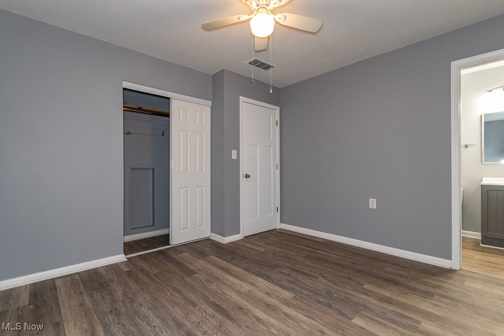 7996 Munson Road Mentor, OH 44060 - Photo 15 of 33 Unfurnished bedroom featuring ceiling fan, dark hardwood / wood-style floors, ensuite bath, and a closet