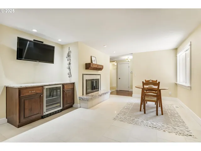 a living room with furniture a flat screen tv and kitchen view