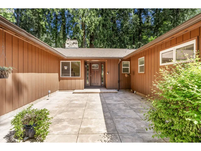 a backyard of a house with flower plants