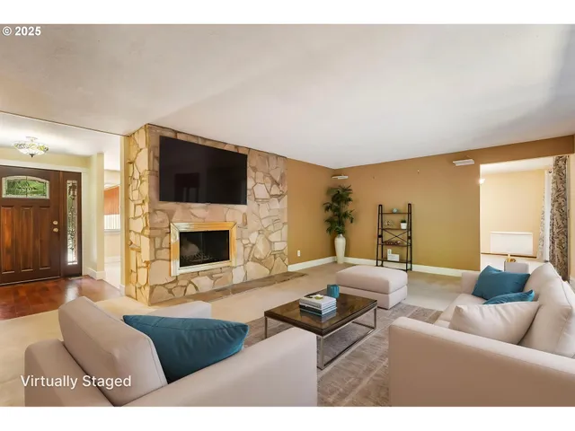 a living room with furniture a flat screen tv and a fireplace