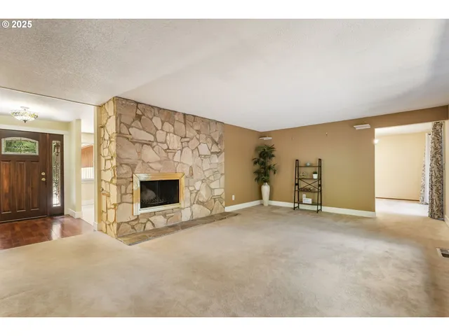 a view of an empty room with a fireplace