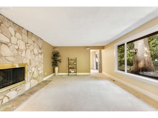 a view of a livingroom with an empty space and a fireplace