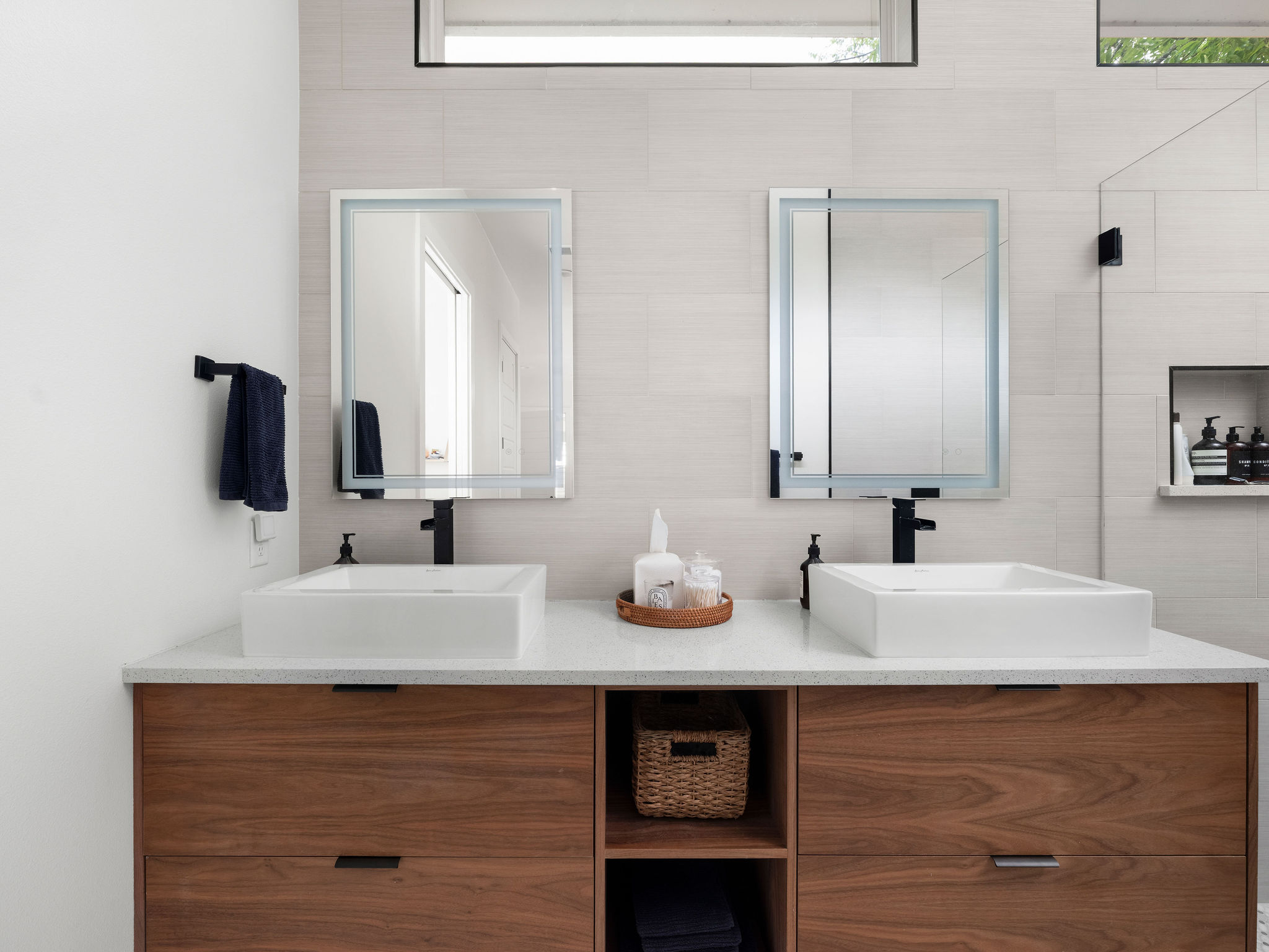 3710 Manorwood Road Austin, TX 78723 - Photo 22 of 40 Dual vessel sinks adorn a handsome wooden vanity, providing both style and practicality.