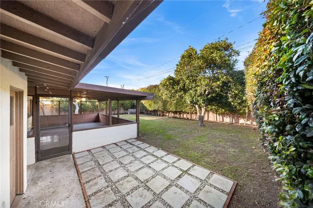 a view of a porch with furniture and a yard
