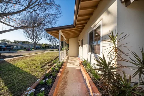a view of a house with backyard and swimming pool