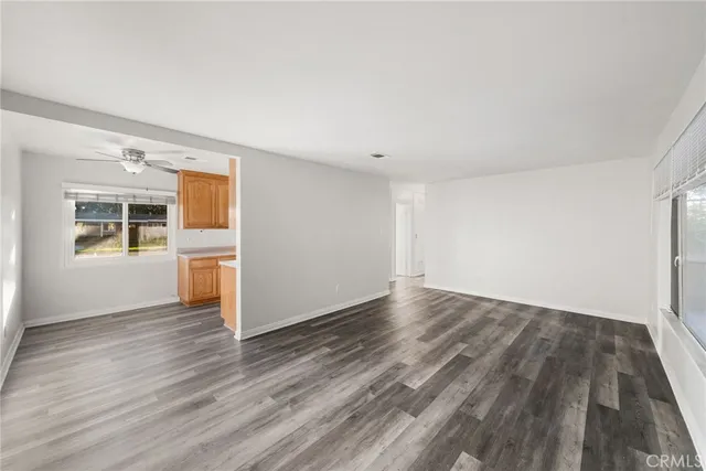 a view of a room with wooden floor and windows